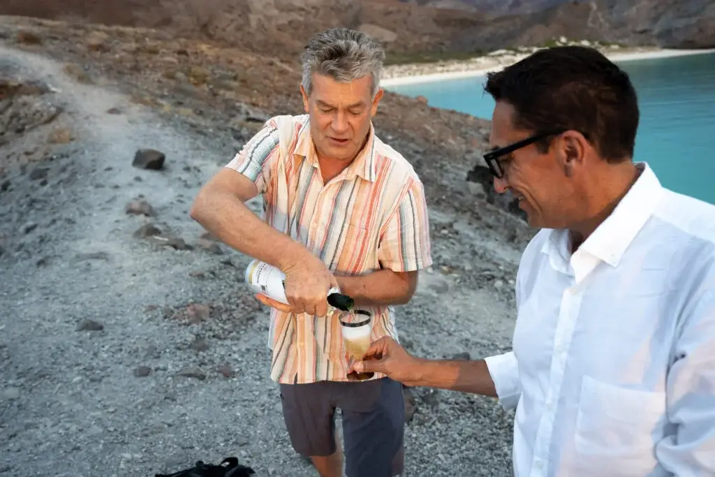 Private trips Guests enjoying a celebratory drink at sunset or sunrise during an exclusive luxury tour on a high vantage point